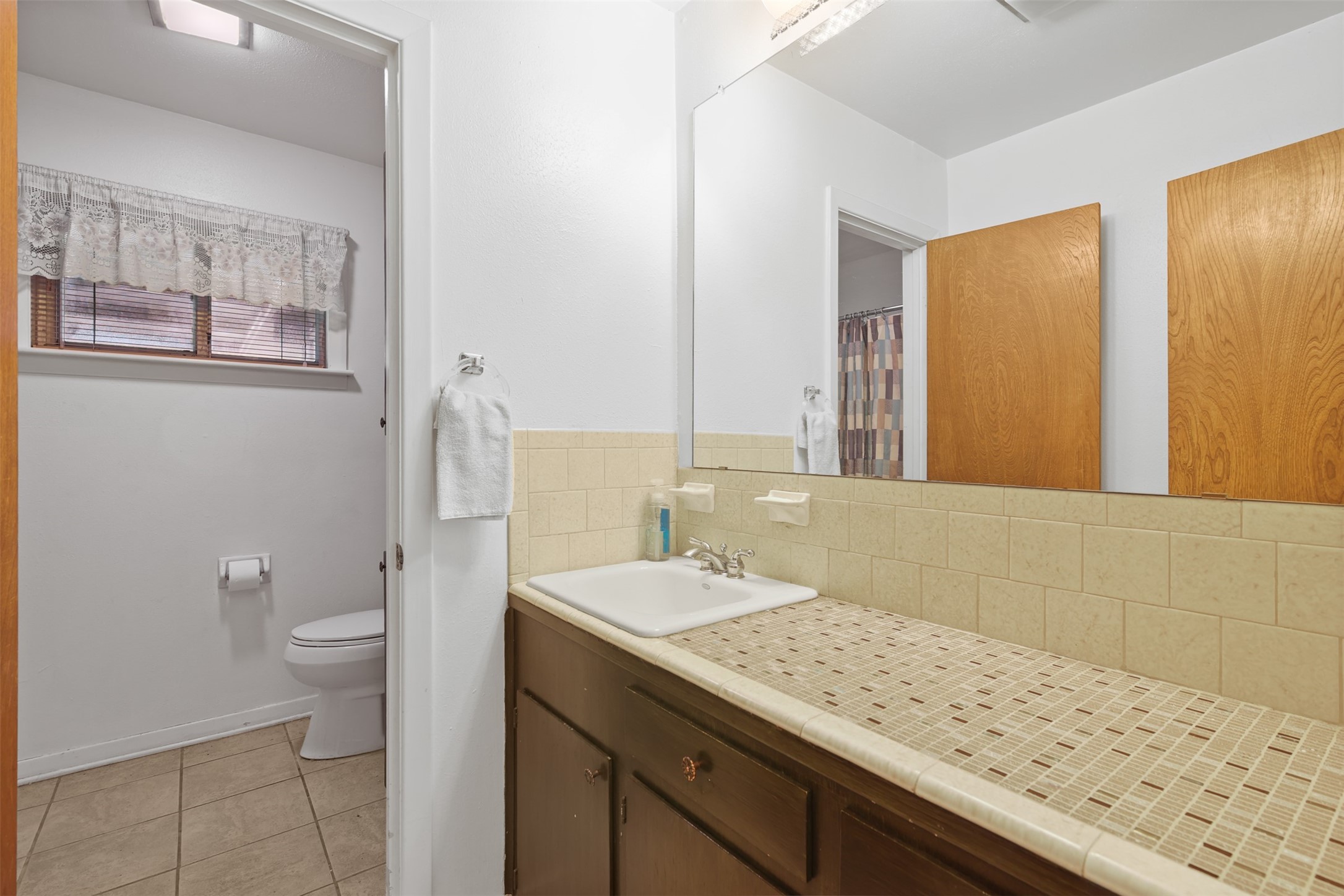 8406 East Mt Houston Road Houston, TX 77050 - Photo 19 of 30 a bathroom with a granite countertop sink a large mirror and toilet