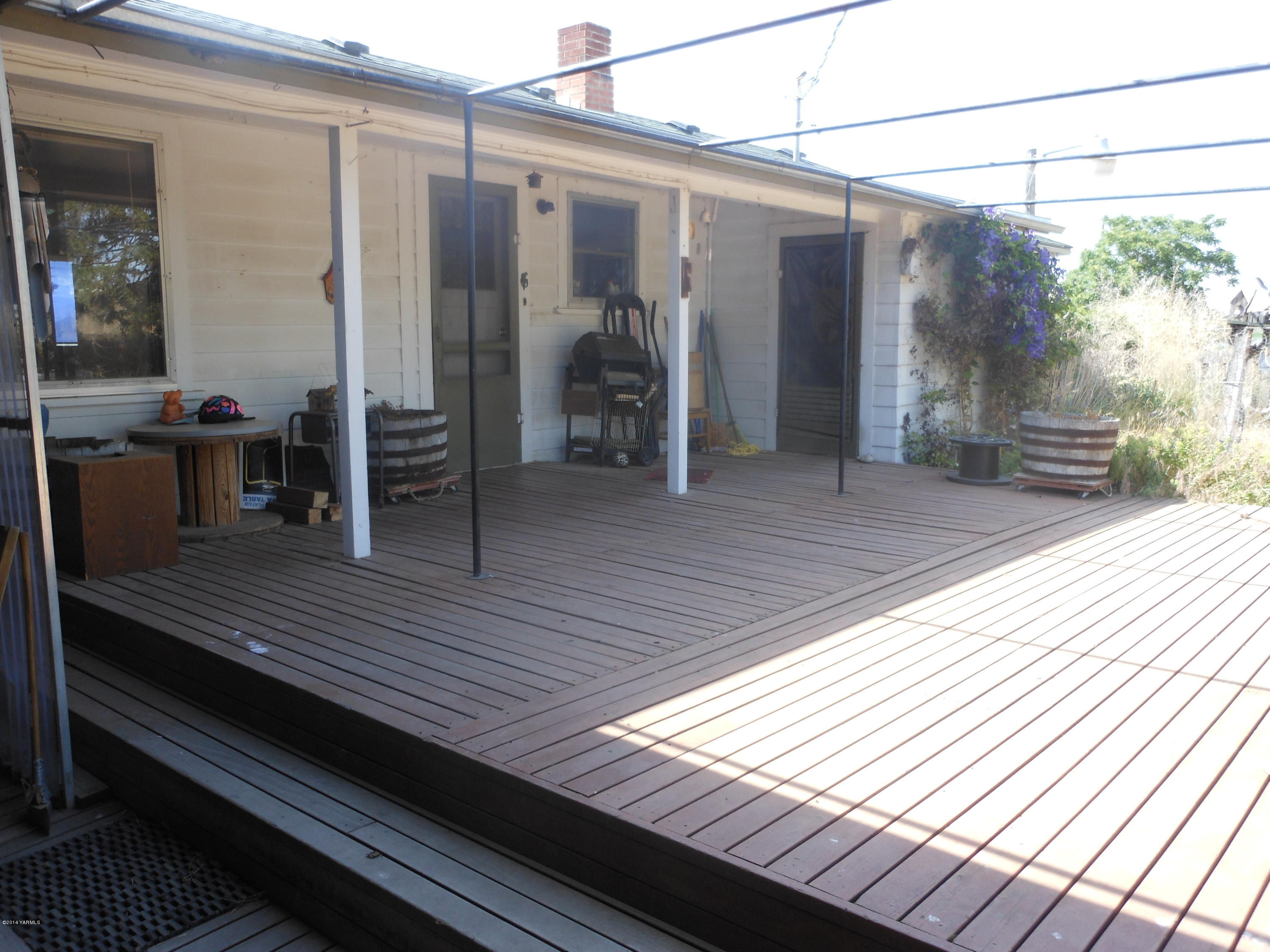 2921 Harrah Road Wapato, WA 98951 - Photo 23 of 29 a view of a balcony with chairs and wooden floor