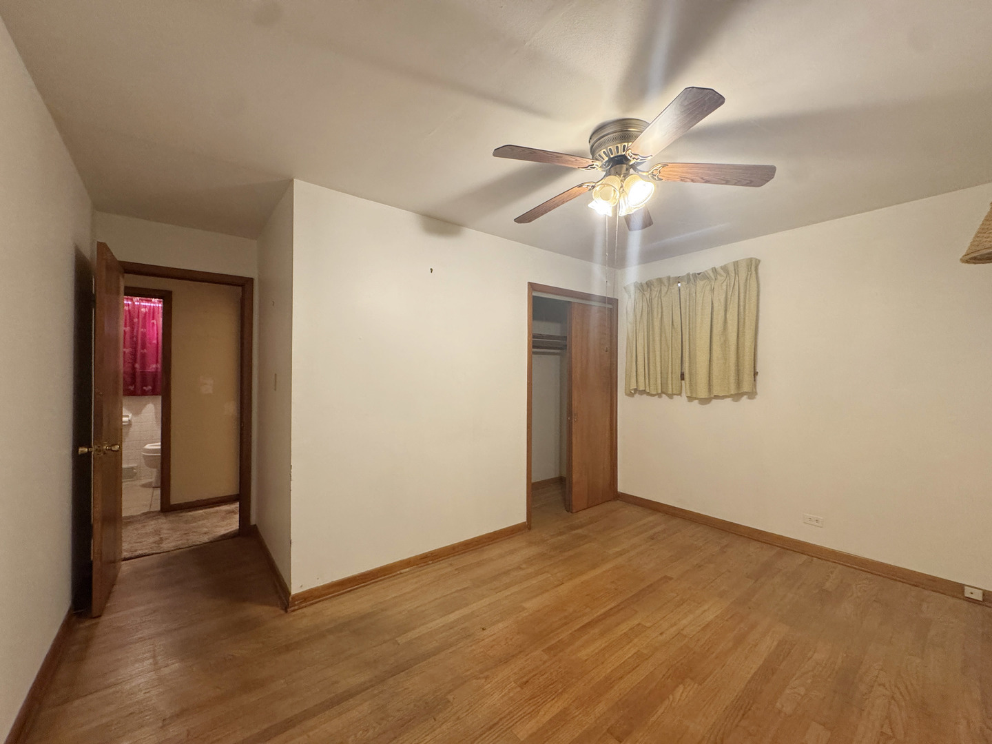112 Iowa Avenue Addison, IL 60101 - Photo 4 of 16 a view of an empty room and window and a ceiling fan