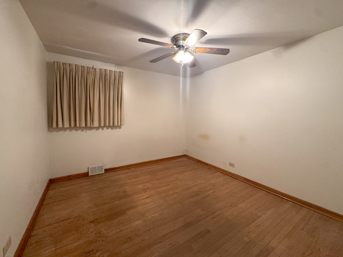 112 Iowa Avenue Addison, IL 60101 - Photo 5 of 16 an empty room with a window and a fan