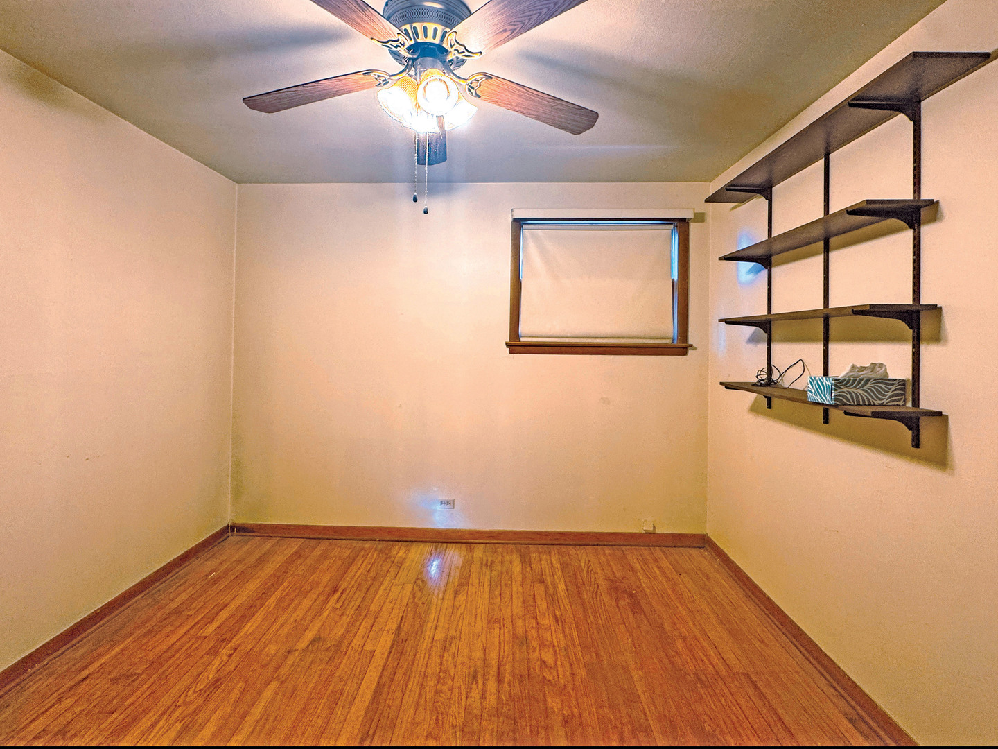 112 Iowa Avenue Addison, IL 60101 - Photo 7 of 16 a view of empty room with wooden floor and fan