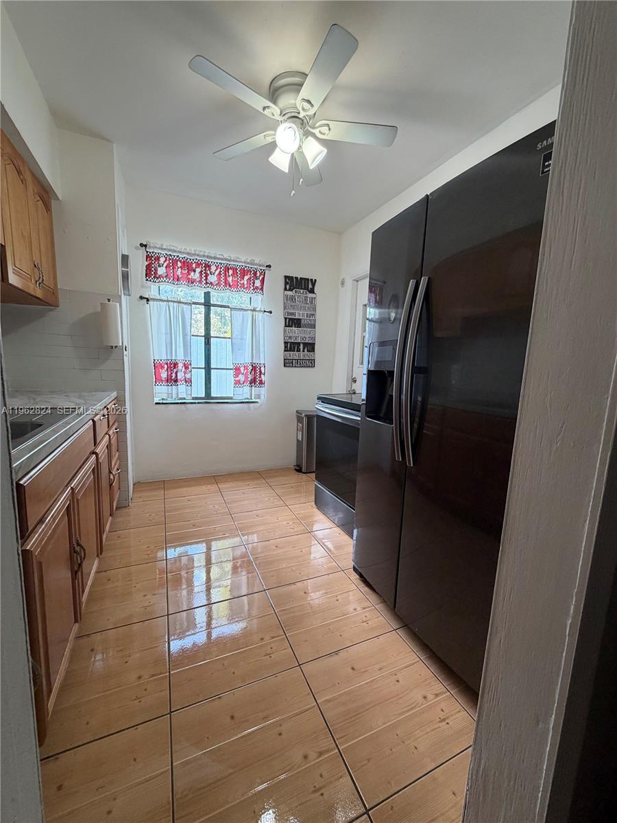2460 Northwest 33rd Street Miami, FL 33142 - Photo 13 of 33 a kitchen with stainless steel appliances a refrigerator and a stove top oven