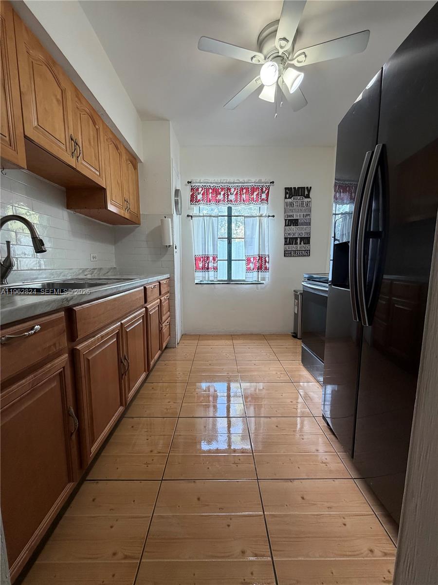 2460 Northwest 33rd Street Miami, FL 33142 - Photo 15 of 33 a kitchen with stainless steel appliances granite countertop a refrigerator and a sink