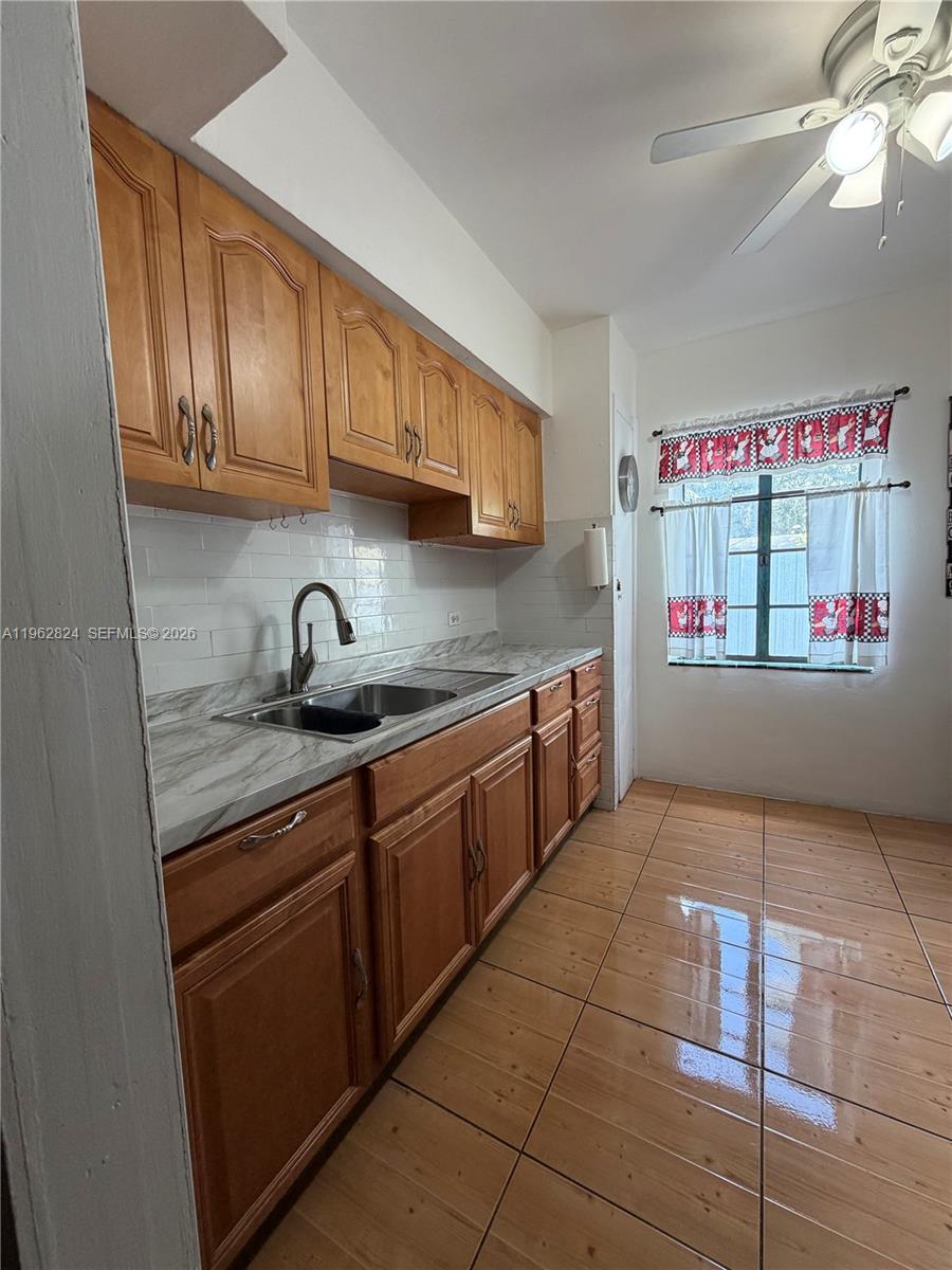 2460 Northwest 33rd Street Miami, FL 33142 - Photo 16 of 33 a kitchen with stainless steel appliances granite countertop a sink and cabinets