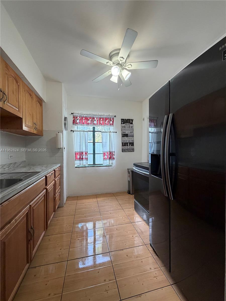 2460 Northwest 33rd Street Miami, FL 33142 - Photo 17 of 33 a kitchen with granite countertop a refrigerator and a sink
