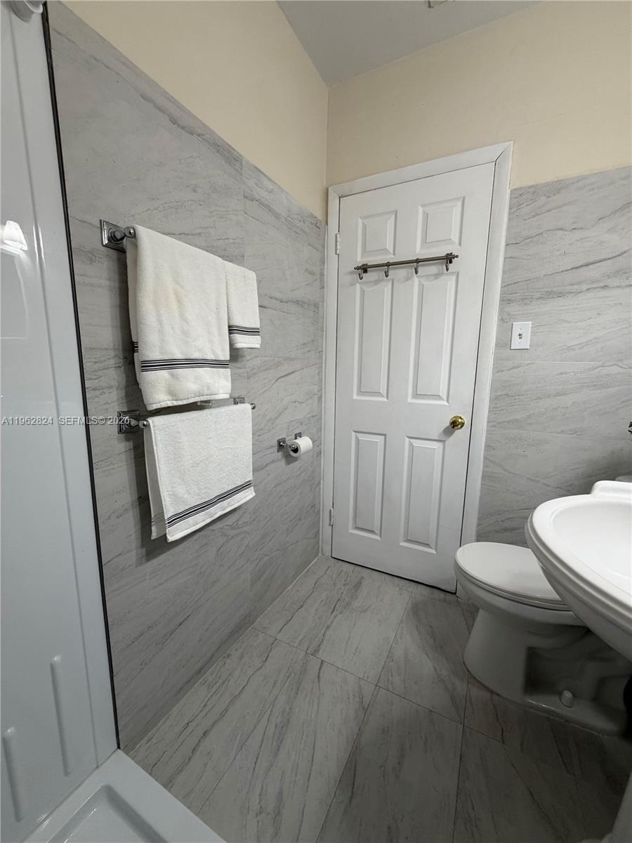 2460 Northwest 33rd Street Miami, FL 33142 - Photo 19 of 33 a bathroom with a toilet sink and tub