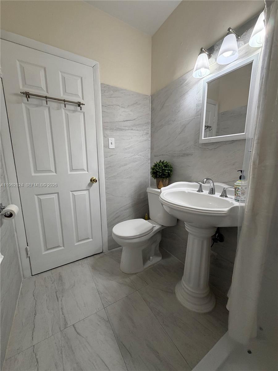 2460 Northwest 33rd Street Miami, FL 33142 - Photo 20 of 33 a bathroom with a sink toilet and shower