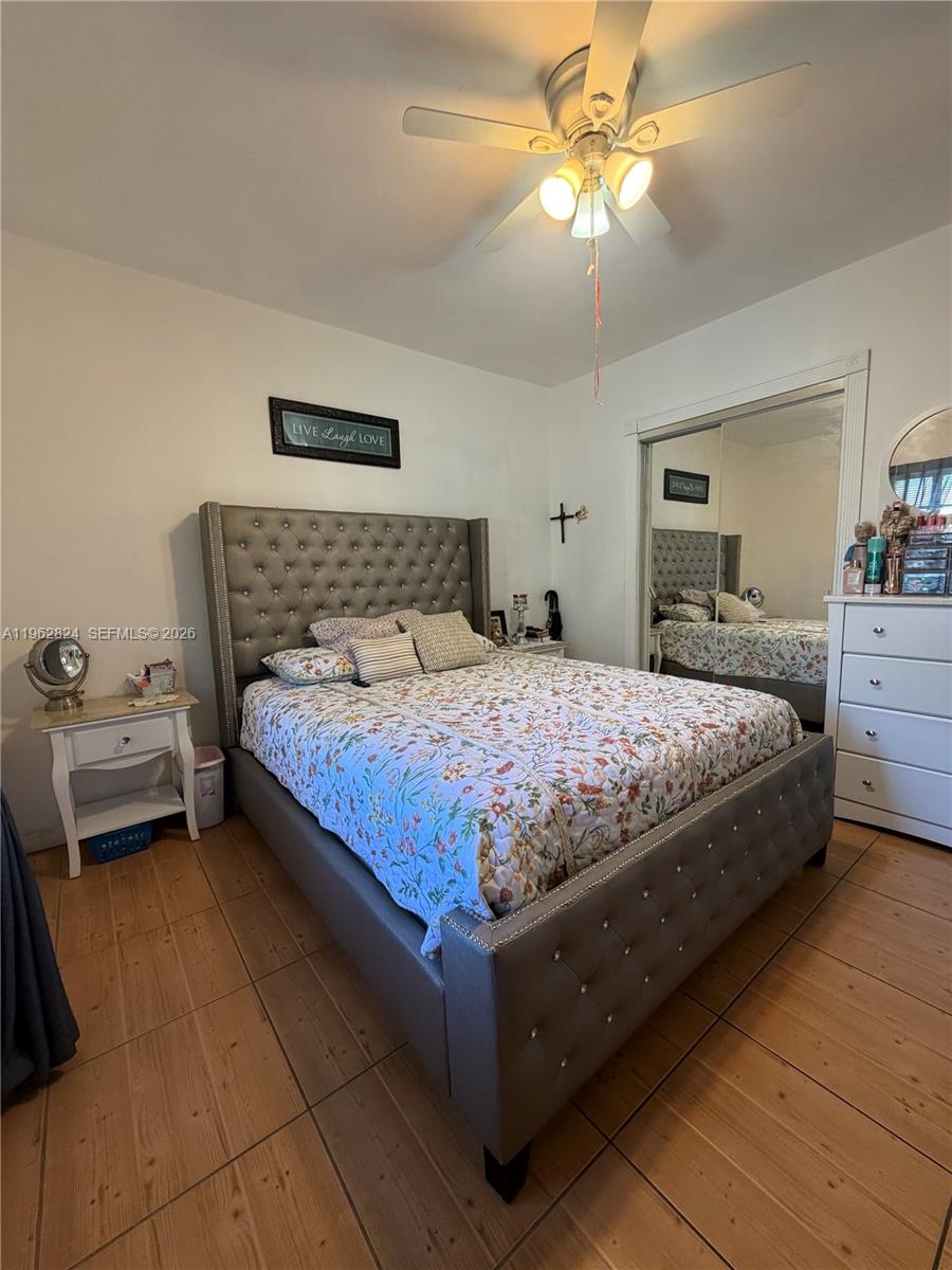 2460 Northwest 33rd Street Miami, FL 33142 - Photo 23 of 33 a bedroom with a bed and a chandelier