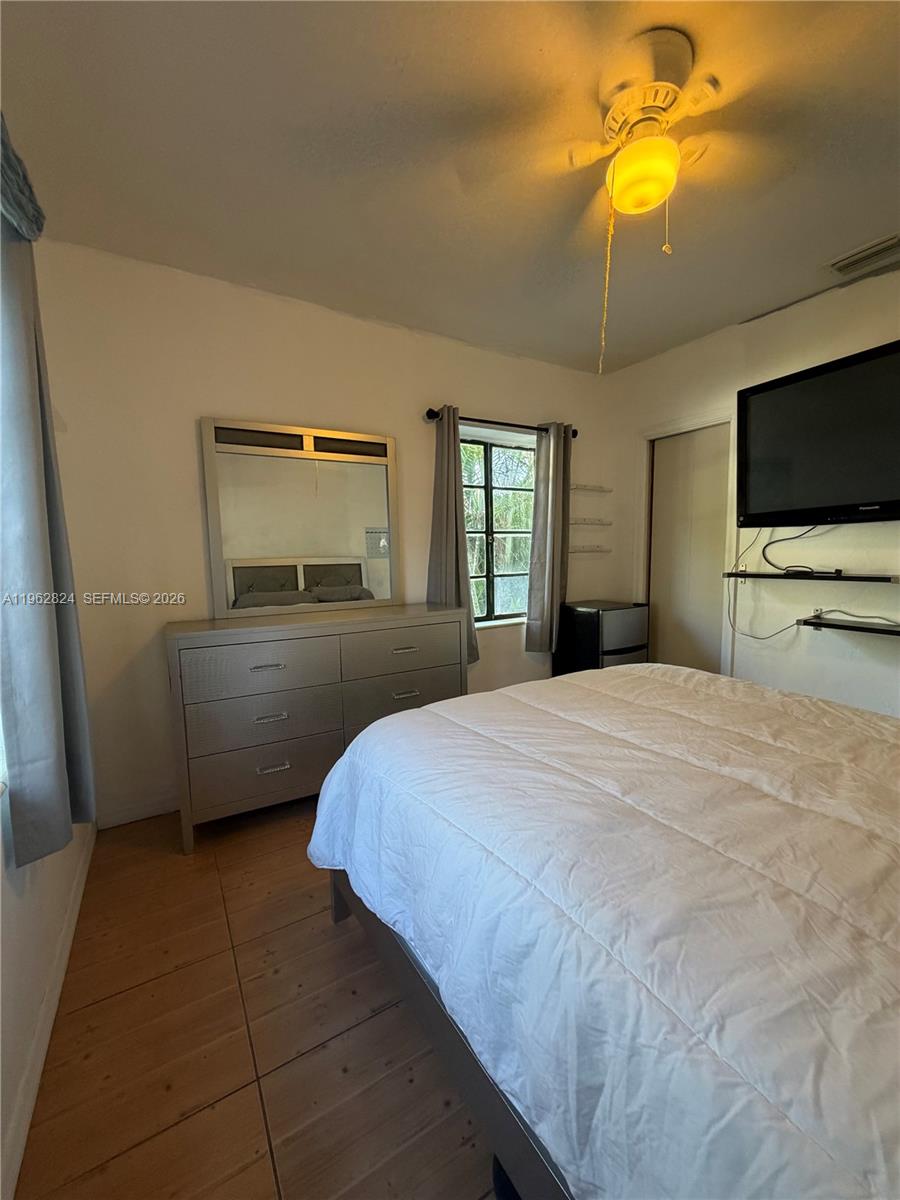 2460 Northwest 33rd Street Miami, FL 33142 - Photo 25 of 33 a bedroom with a bed and a flat screen tv