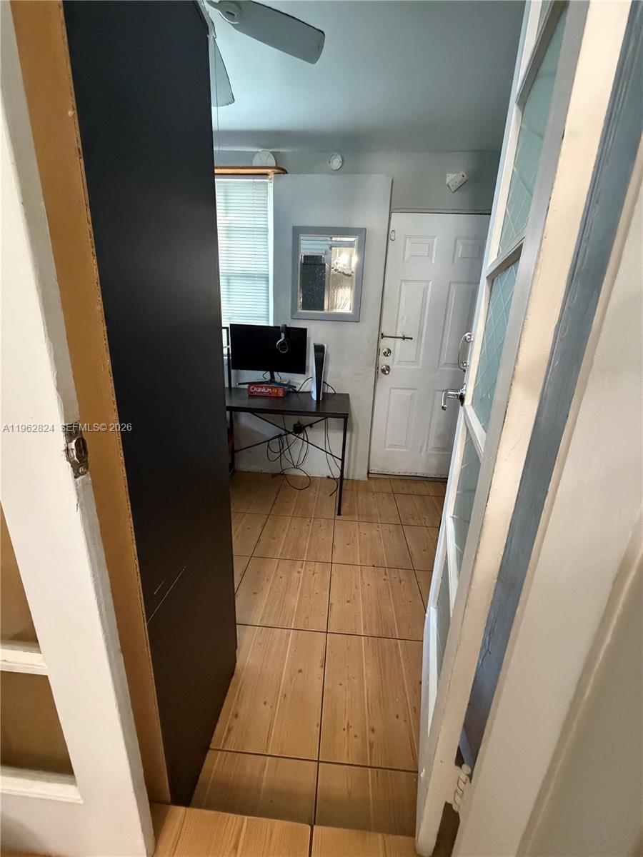 2460 Northwest 33rd Street Miami, FL 33142 - Photo 29 of 33 a view of an empty room with wooden floor and furniture