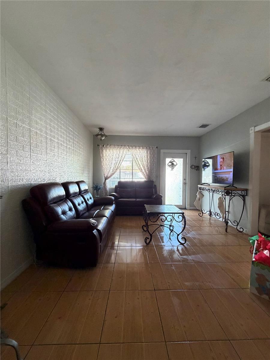 2460 Northwest 33rd Street Miami, FL 33142 - Photo 4 of 33 a living room with furniture and a window