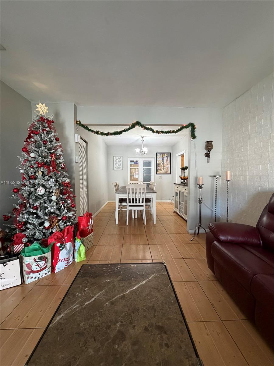 2460 Northwest 33rd Street Miami, FL 33142 - Photo 5 of 33 a living room with furniture and flowers