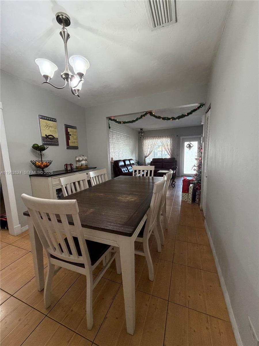 2460 Northwest 33rd Street Miami, FL 33142 - Photo 10 of 33 a very nice looking dining room with a table chairs and a chandelier