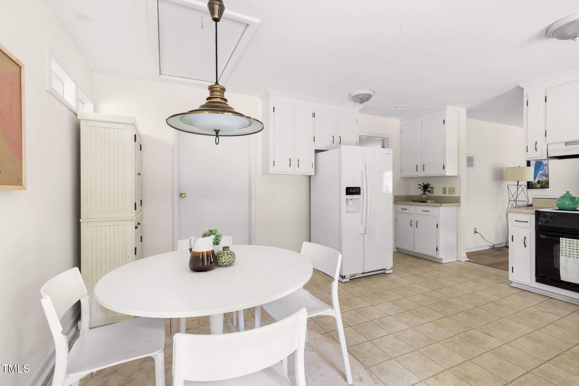 324 Woodhaven Road Chapel Hill, NC 27514 - Photo 15 of 32 a kitchen with stainless steel appliances a table and chairs in it