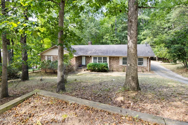 a front view of a house with yard patio and fire pit
