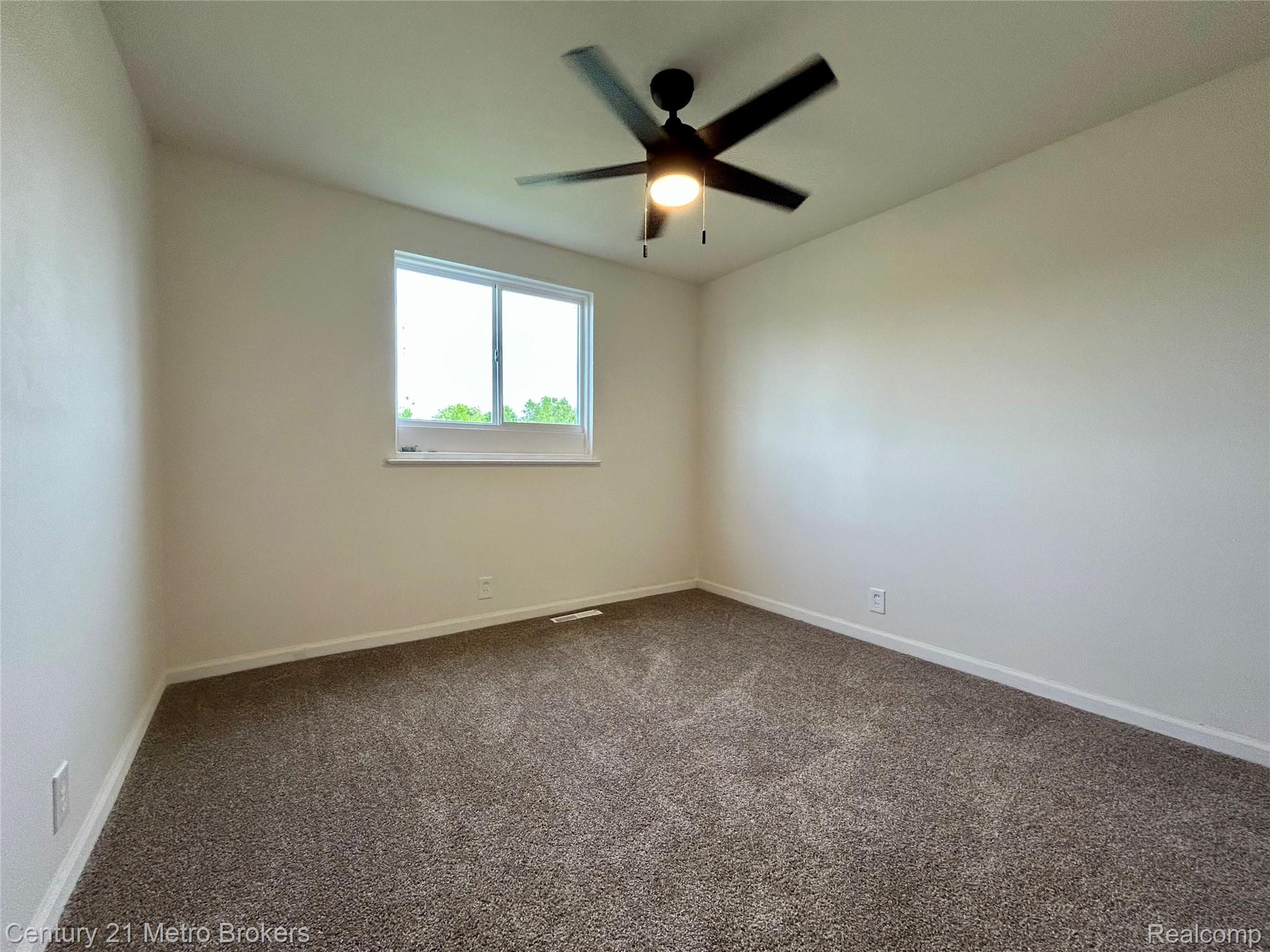 6187 Eldon Road Mount Morris, MI 48458 - Photo 8 of 10 Spare room featuring dark carpet and ceiling fan