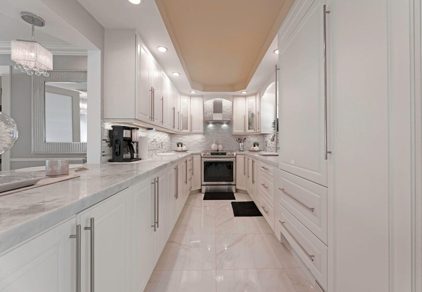 2935 Lake Worth Road Palm Springs, FL 33461 - Photo 11 of 22 a kitchen with white cabinets and white appliances