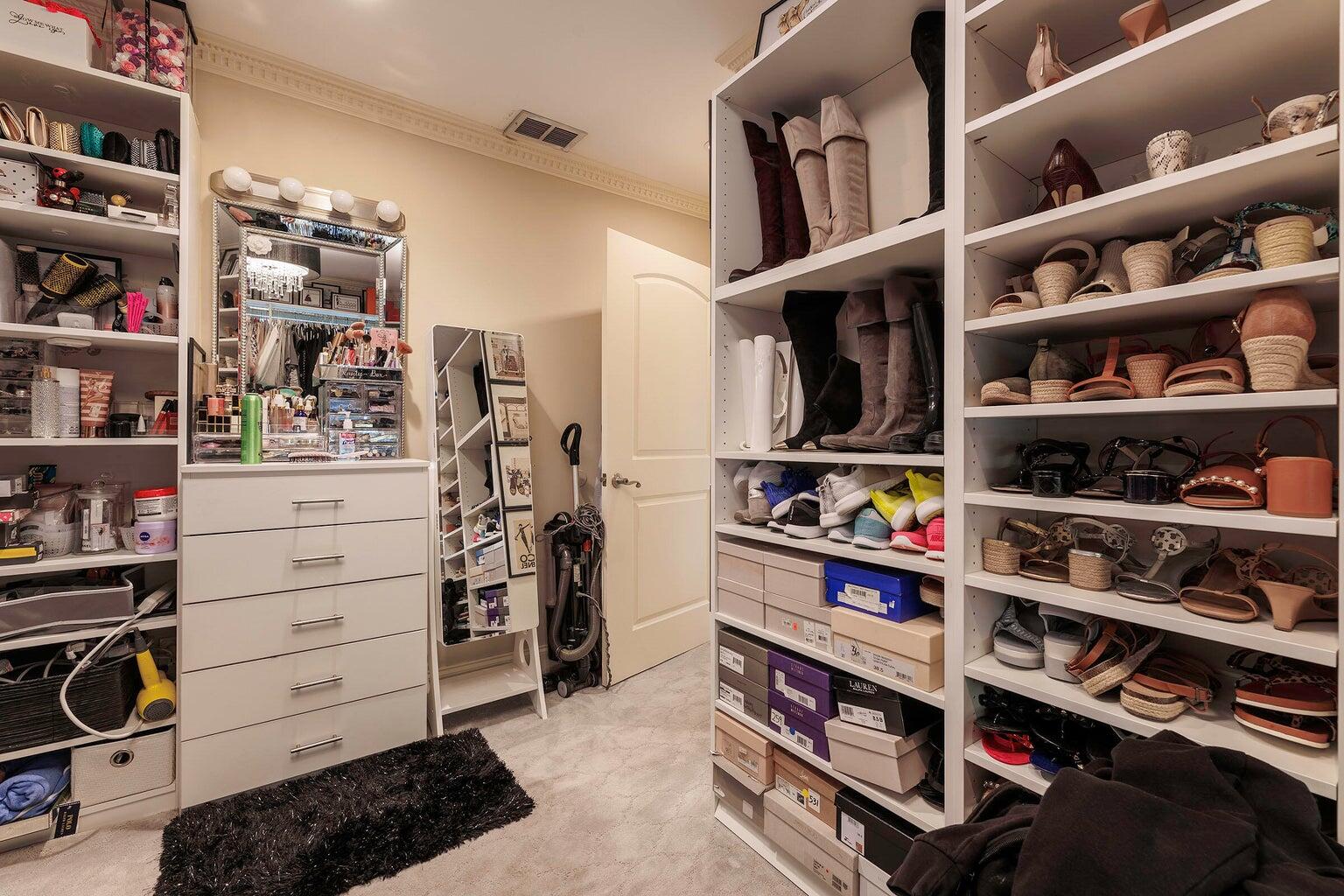 2935 Lake Worth Road Palm Springs, FL 33461 - Photo 16 of 22 a view of walk in closet with clothes and shoes