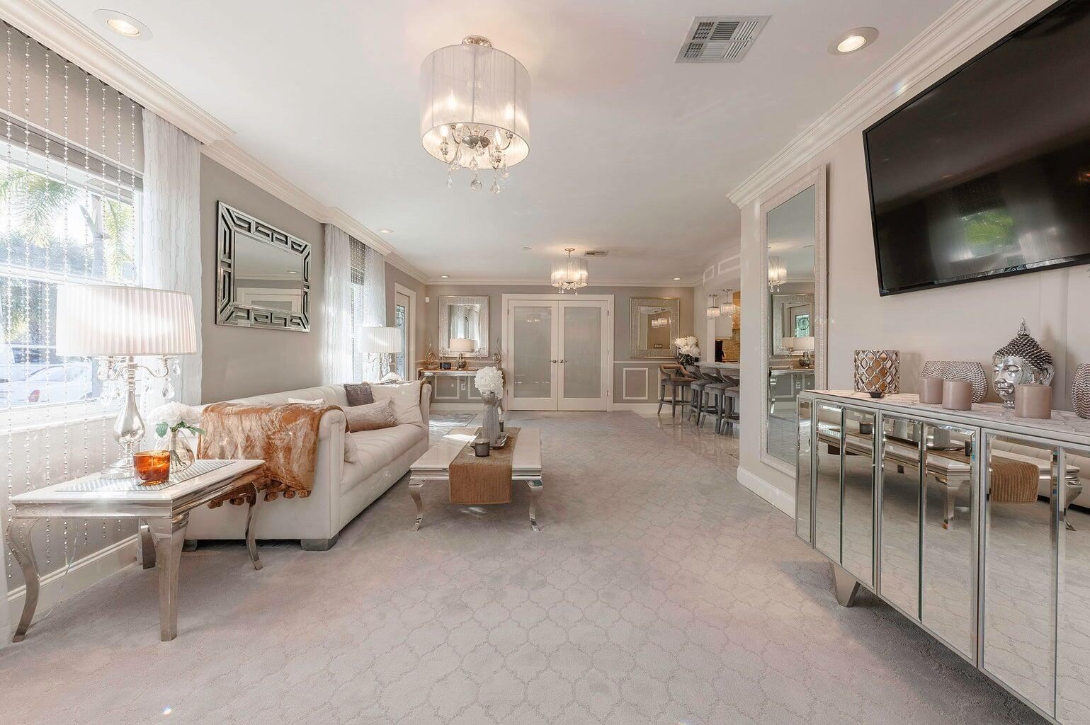 2935 Lake Worth Road Palm Springs, FL 33461 - Photo 7 of 22 a living room with furniture a flat screen tv and kitchen view