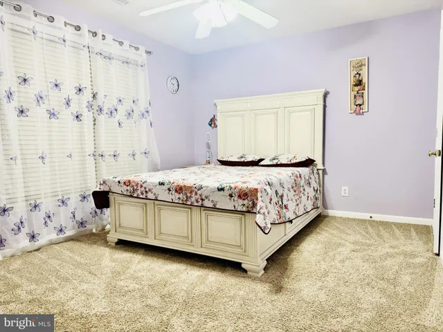 a bedroom with a bed and painting on the wall