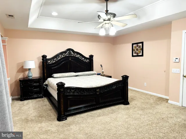 a spacious bedroom with a bed and a chandelier