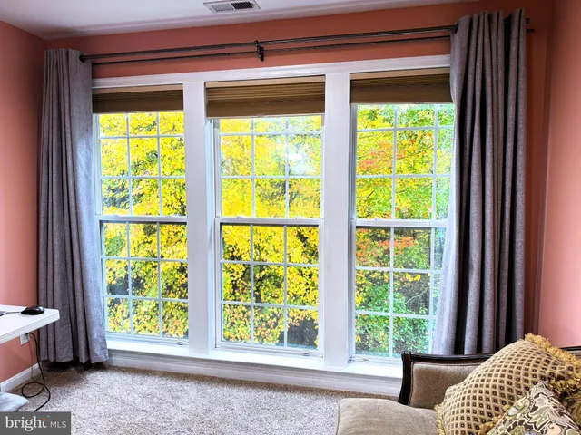 a view of a bedroom with a bed and a window