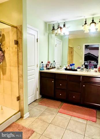 a spacious bathroom with a sink mirror and shower