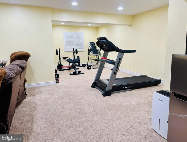 a room with gym equipment and a flat screen tv