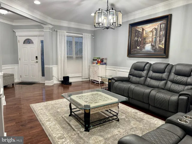 a living room with furniture a rug and a chandelier