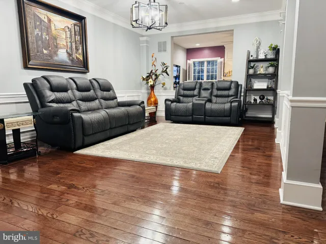 a living room with furniture bathtub and wooden floor