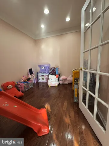 a room with wooden floor and furniture