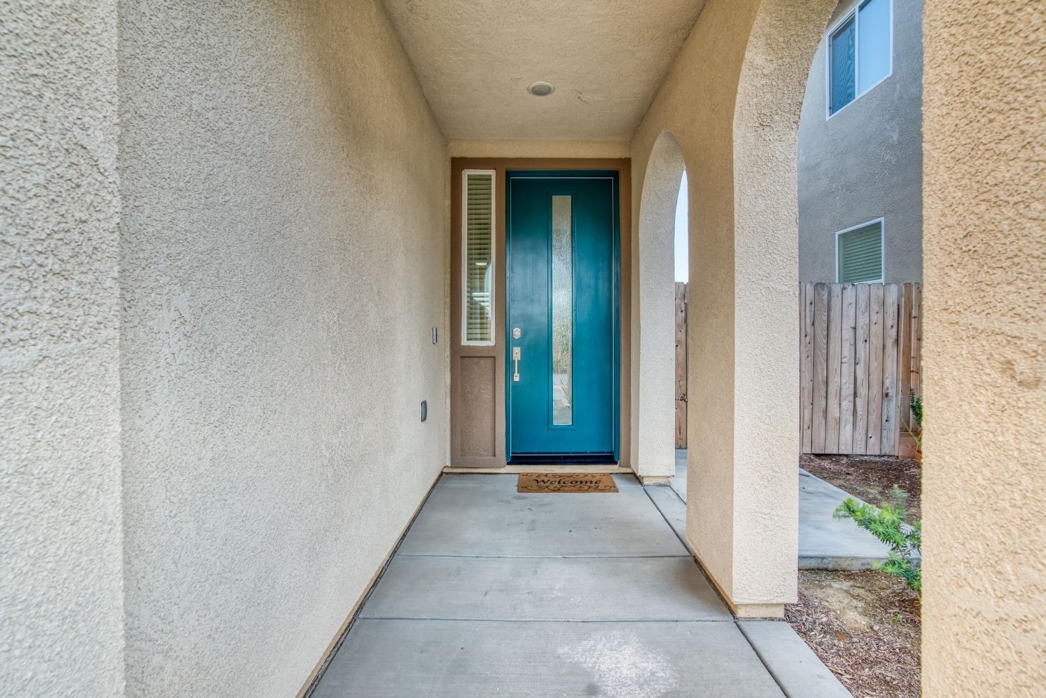 3678 Parkstone Way Clovis, CA 93619 - Photo 2 of 34 a view of a hallway with wooden floor and a bathroom