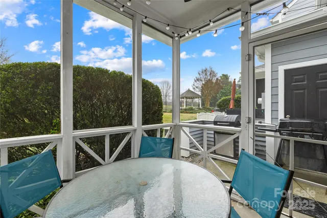 a view of a chairs and table in the balcony