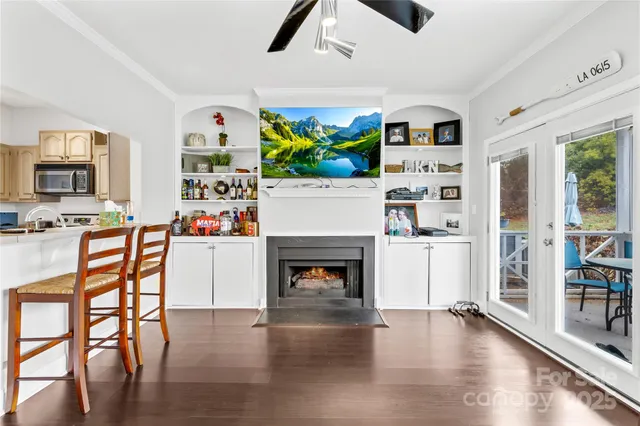 a living room with furniture wooden floor and a fireplace