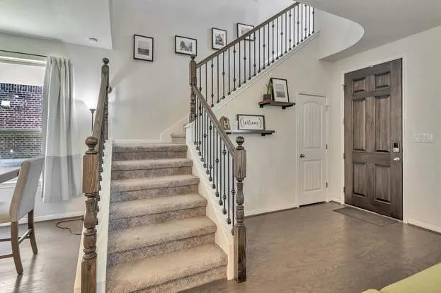a view of entryway and hall with wooden floor