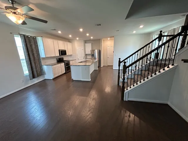 a view of a dining room with furniture a chandelier and wooden floor