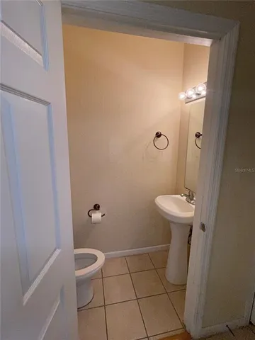 a bathroom with a granite countertop toilet and a shower