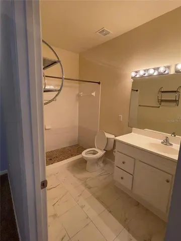a bathroom with a toilet and a shower