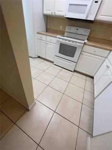 a stove top oven sitting inside of a kitchen