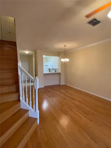 a view of entryway and hall with wooden floor