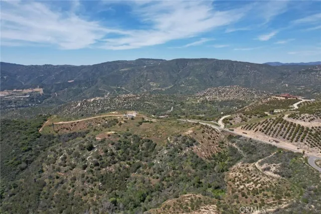 a view of a dry yard with mountains in the background