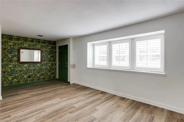 a kitchen with stainless steel appliances kitchen island granite countertop a refrigerator and a sink