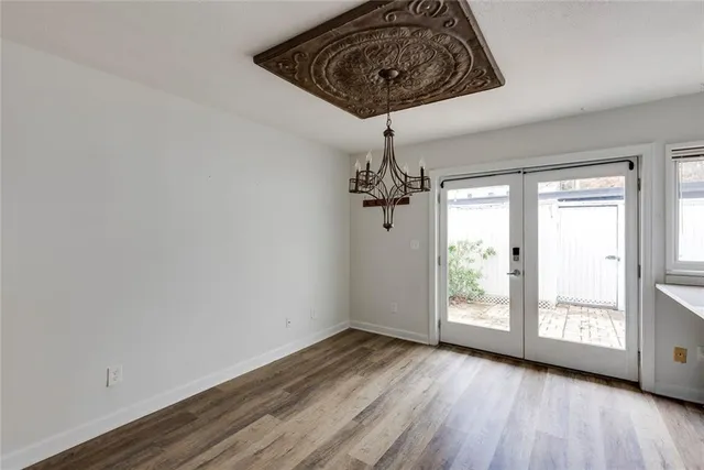 a kitchen with stainless steel appliances granite countertop a stove a refrigerator and a wooden floors