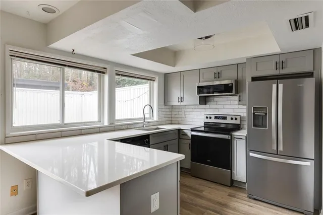 a kitchen with a sink stove and cabinets