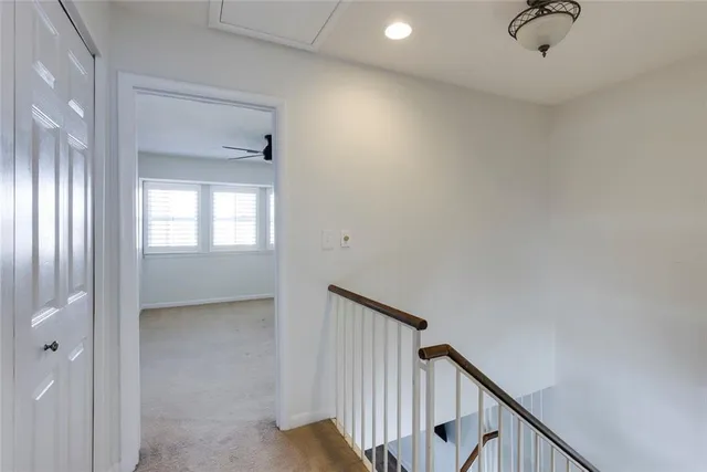 a view of a livingroom with a ceiling fan and window