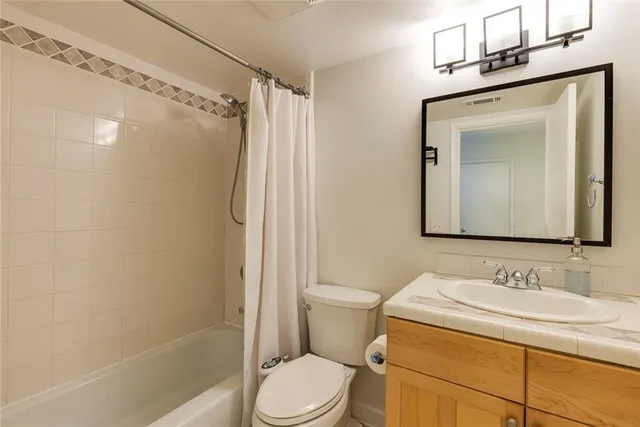 an empty room with windows and cabinet