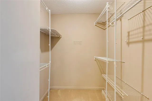 a view of an empty room with a ceiling fan