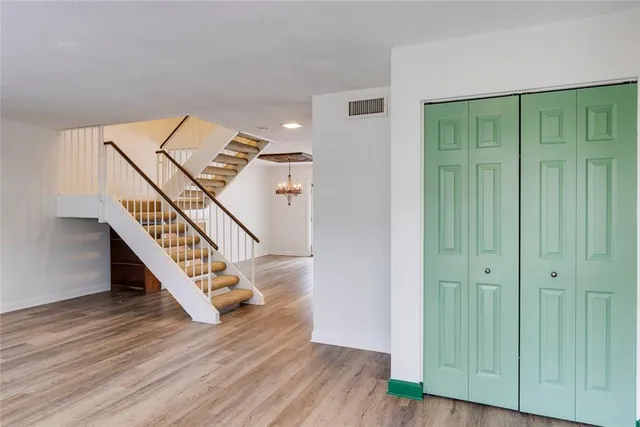 an empty room with wooden floor and a window