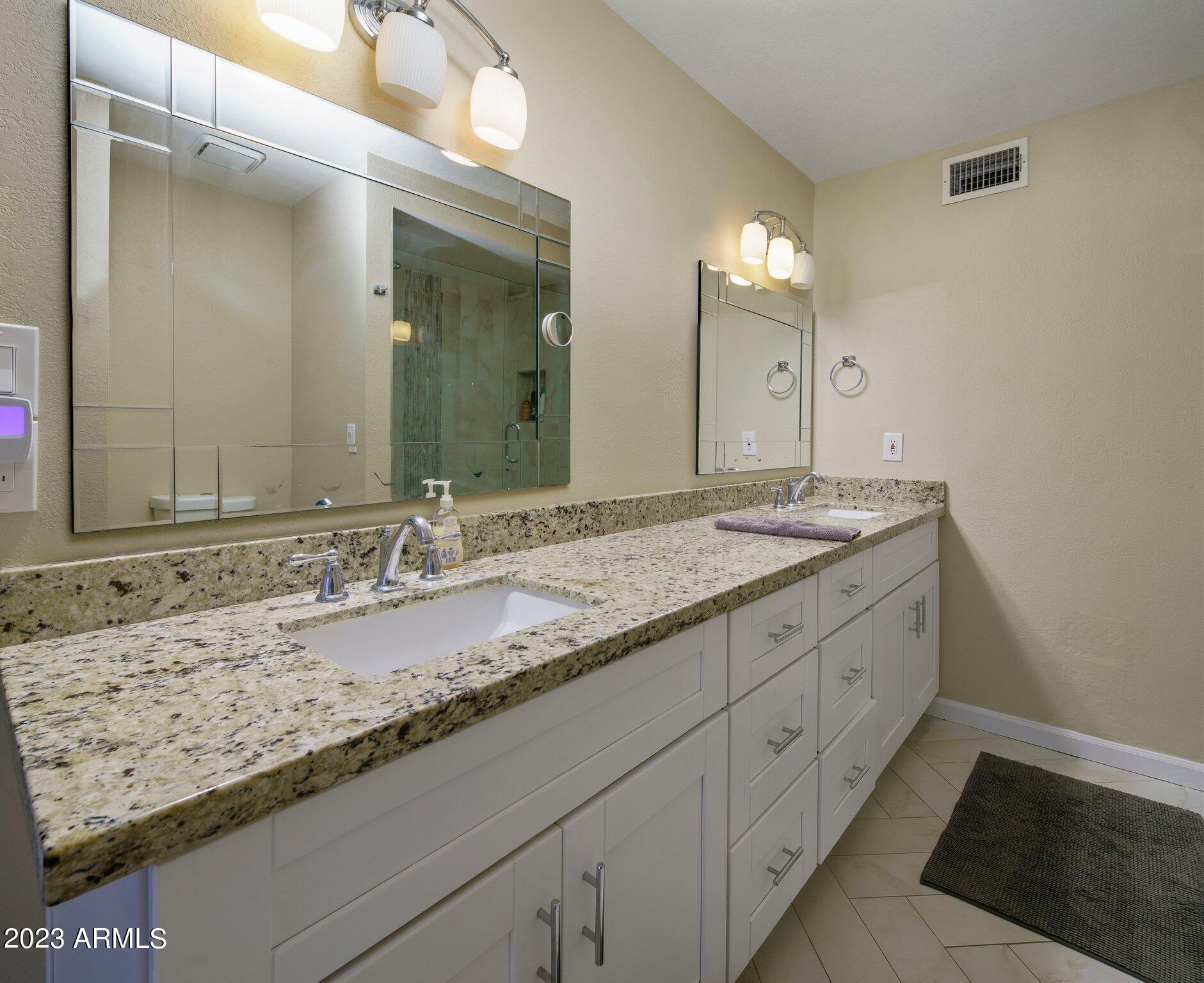 6609 East Phelps Road Scottsdale, AZ 85254 - Photo 18 of 83 a bathroom with a granite countertop sink double and mirror