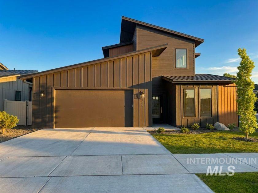 Contemporary architectural design with a dark brown exterior and a varied roofline